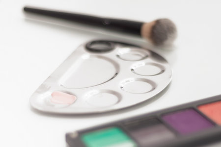 palette with shadows, makeup brush and mixing tray on the make-up tableの写真素材