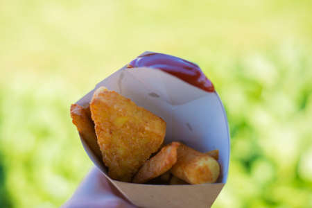 Fast food: breaded baked potatoes and cheese sticks with sauce