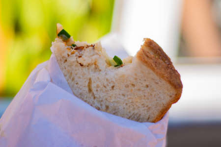 Fast food: bitten sandwich in a napkin