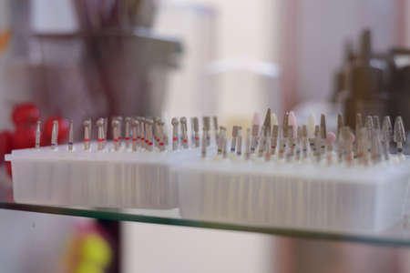counter with goods for nail service, nozzles for hardware manicure