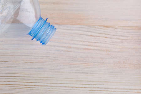 part of a plastic bottle on a wooden backgroundの写真素材