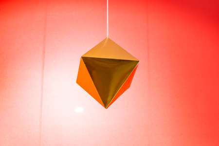 interior decor: golden hexagon hanging on a stringの写真素材