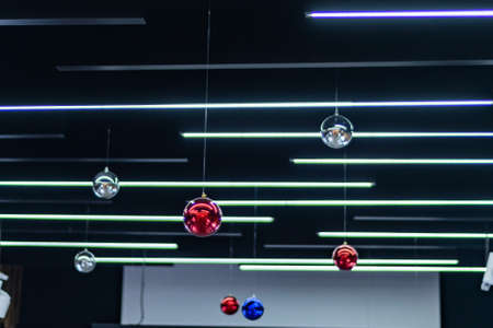 interior decor: multicolored Christmas balls suspended from the ceiling
