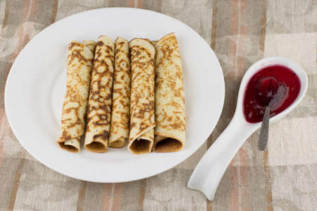 the celebration of carnival: fresh cooked real Russian pancakes made of buttermilk, rolled into a...