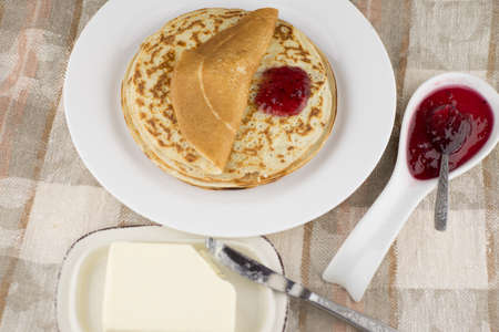 the celebration of carnival: fresh cooked real Russian pancakes made with yogurt, on a white plate,...