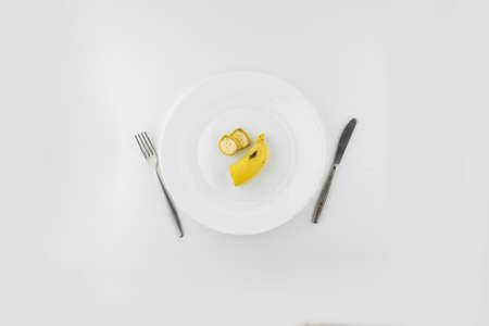 vegan diet: several banana slices on a white plate, Cutleryの写真素材