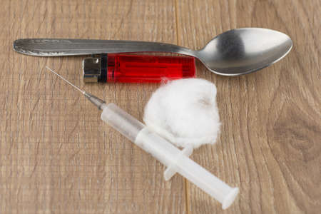 recruitment of occured injecting drug users: syringe, spoon, cotton wool and a lighter lie on the...