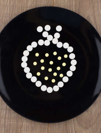 treatment chemicals: a sign of strawberries built from refocusing white tablets on a black plate...