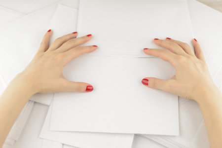 work with correspondence: Girl rakes a lot of empty envelopes with two hands