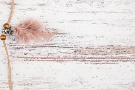 small Handmade dream catcher with feathers threads and beads rope hanging on a light background Board closeの写真素材