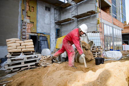A builder in work clothes is doing his jobの写真素材