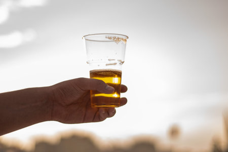 beer in a plastic glass in handの写真素材