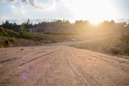 a long road of rubble along the quarry and forestの写真素材