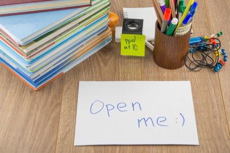 student desktop, books, accessories, stationery. in the foreground is a mysterious envelope with the...