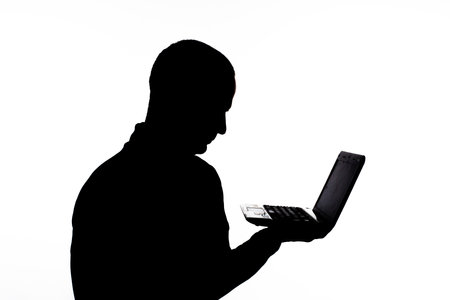 silhouette: guy on a white background holds a netbook in handsの写真素材