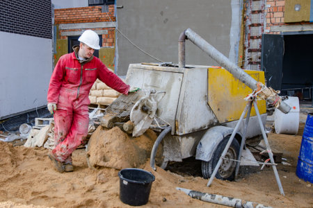 A builder in work clothes is doing his job