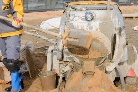 Builder in work clothes prepares tools and materialsの写真素材