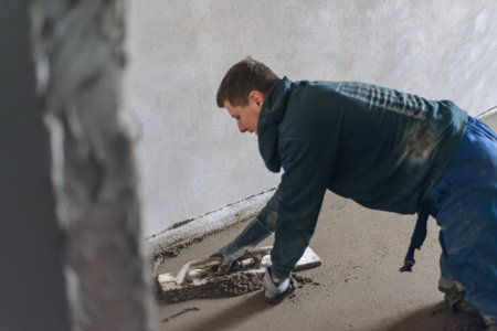 A builder in work clothes is doing his jobの写真素材