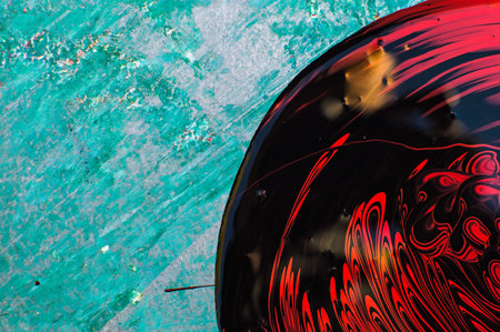 abstract background with black and red circles in water, close upの写真素材