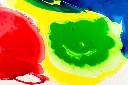 Colorful background of oil paint splashes on a white background.