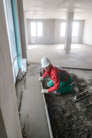 A builder in work clothes is doing his jobの写真素材