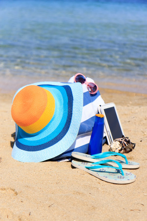 Colorful hat and bag on the beachの写真素材