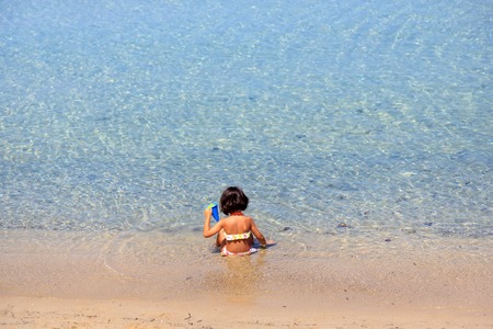 Girl playing on the beachの写真素材