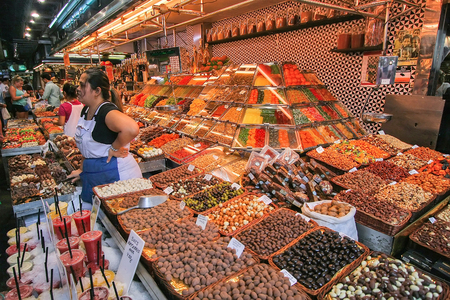 People buying food inside Mercat de Sant Josep de la Boqueria. It is a large public market in the Ciutat Vella district of Barcelona.のeditorial素材