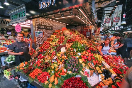People buying food inside Mercat de Sant Josep de la Boqueria. It is a large public market in the Ciutat Vella district of Barcelona.のeditorial素材
