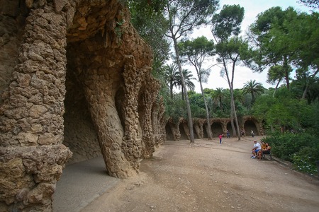 Tourists in the amazing Park Guel in Barcelona. Park Guell is the famous architectural town art designed by Antoni Gaudi.のeditorial素材
