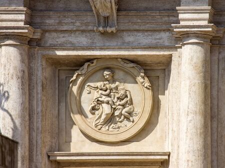 Emblem with mother and children in buliding in Rome, Italyの写真素材