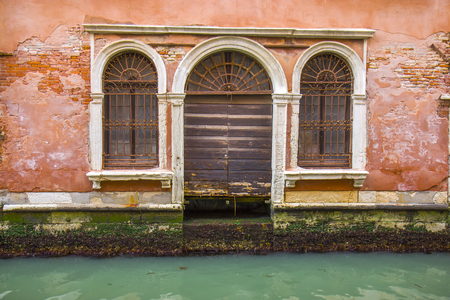 Old door in the Venice canalの写真素材