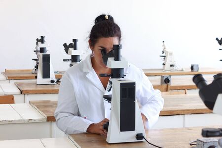 Woman in the research laboratory with microscopeの写真素材
