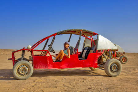 Girl driving buggy in the desert