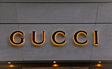 ZURICH, SWITZERLAND - AUGUST 3, 2022: Logotype logo sign of Gucci is an Italian luxury brand of fashion and leather goods, part of the Gucci Group, which is owned by the French holding company Keringのeditorial素材