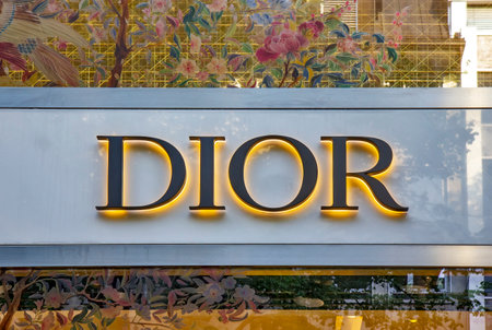 ZURICH, SWITZERLAND - AUGUST 3, 2022: Close up of Dior store projecting sign on the building. Christian Dior SE, commonly known as Dior, is a French luxury fashion house.のeditorial素材