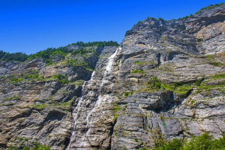 View of the great waterfall in the mountain in Swiss alpsの写真素材