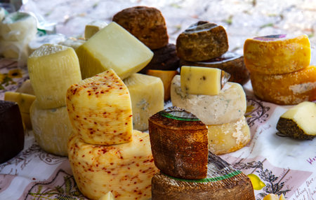 Various types of cheese on the table on the marketの写真素材