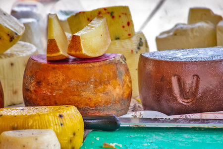 Various types of cheese on the table on the market