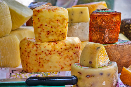 Various types of cheese on the table on the marketの写真素材