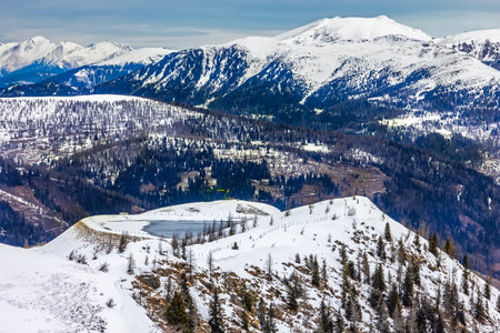 View of the snowy mountain landscape with winter forest