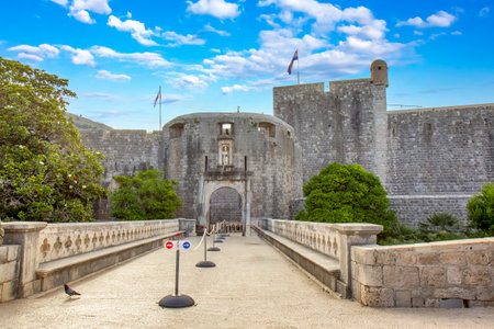A frontal view of Bokar Castle, a prominent medieval fortress in Dubrovnik, Croatia, with its stone walls, historic gate, and a pedestrian bridge leading into the old city. A classic representation of Croatiaâs architectural and cultural heritage.の写真素材