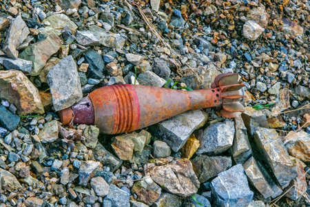 A close-up view of a rusted mortar shell or similar unexploded ordnanceの写真素材