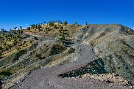 A winding, unpaved road traversing a steep in Kurdistanの写真素材