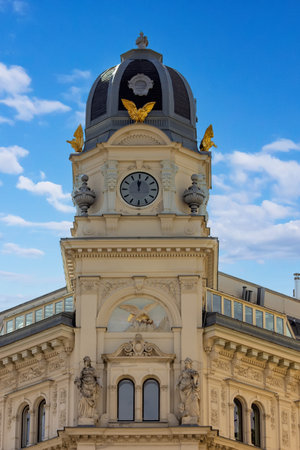 The ornate clock tower atop a historic Vienna buildingの写真素材