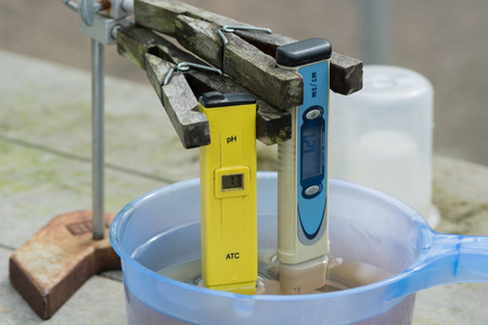 Measuring the pH of the water in hydroponic farm. Electronic pH meter