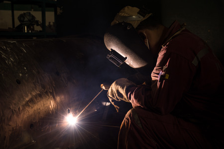 Worker welding repair spare part by SMAW processの写真素材