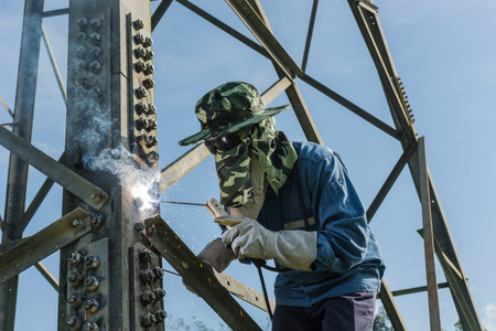 Welder work at high Electric high voltage pole 230 Kv