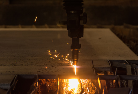 Metal cutting with acetylene torch by auto cutting machine close-up on low lightの写真素材
