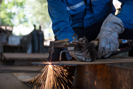 Woker cutting metal steel plate by process oxygen and acetylene,industrial worker on manufacturing area.の写真素材